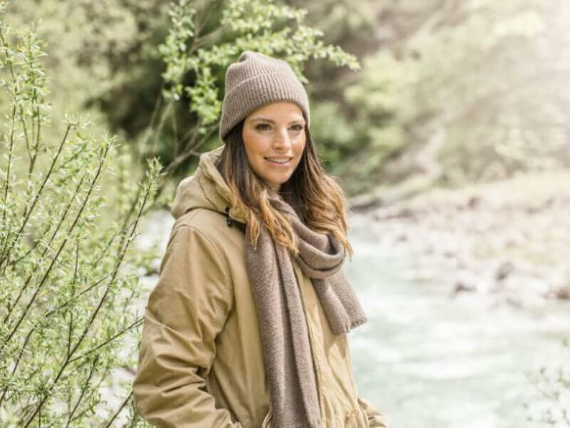 Vrouw draag Fellhof muts Dachstein en sjaal Attersee kleur aarde